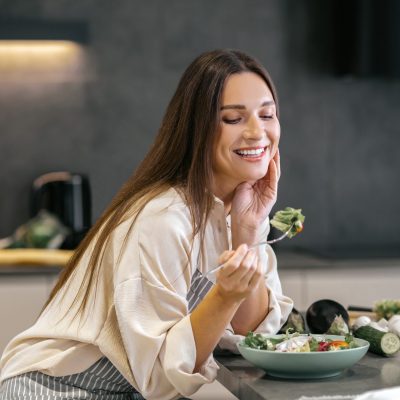 Smiling happy woman eating with appetite Lunch time. Smiling happy woman eating with appetite
