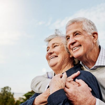 Sky, elderly couple and hug outdoors or happy in retirement or husband and wife in nature. Mature, man and woman smile in vacation or senior citizens care and embrace or date at the park for romance Sky, elderly couple and hug outdoors or happy in retirement or husband and wife in nature. Mature, man and woman smile in vacation or senior citizens care and embrace or date at the park for romance.